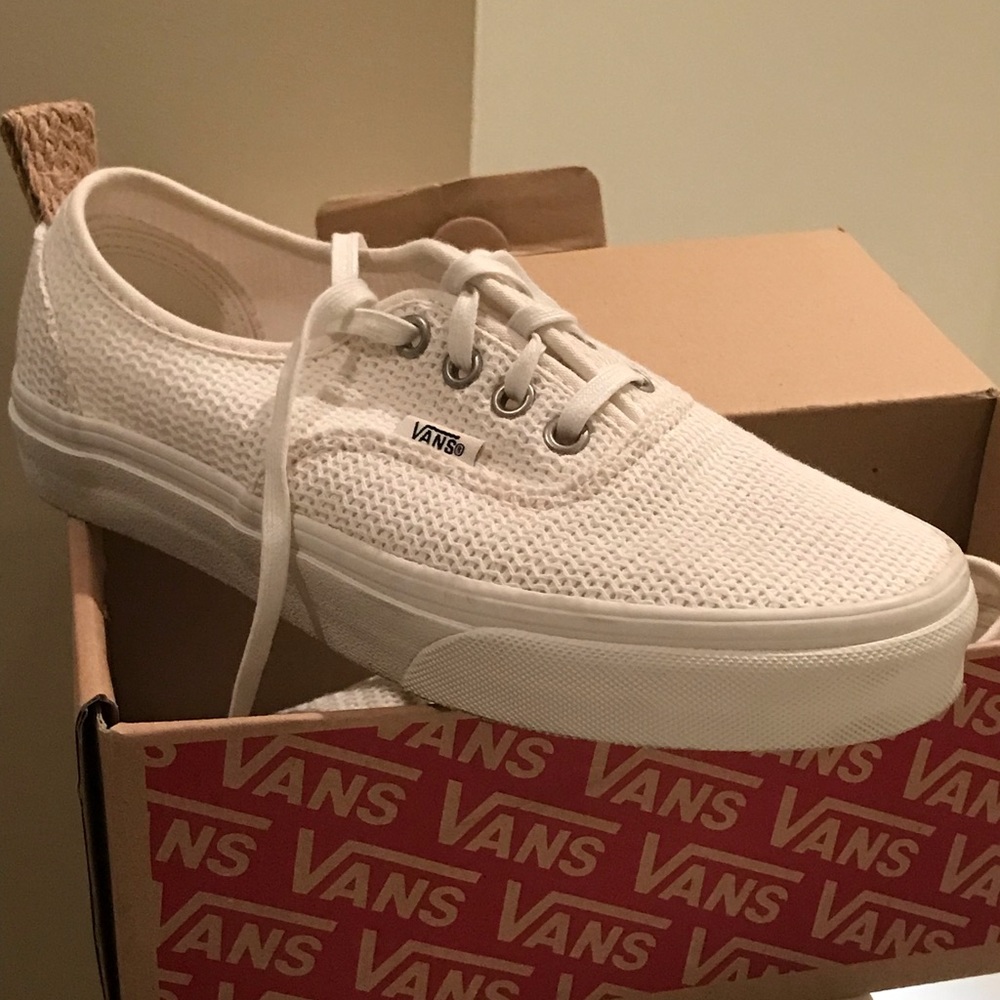 A pair of Ladies cream colored Vans sneakers